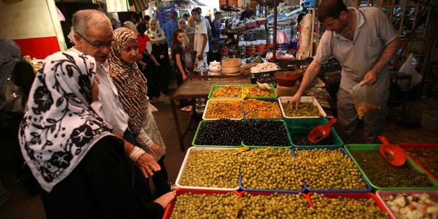 People shop at Ali Mellah market in Algiers on July 27, 2011. Faced with crumbling regimes across the Arab world, Algeria has dramatically boosted its grain imports to contain social unrest ahead of Ramadan, when food prices traditionally shoot up. AFP PHOTO FAROUK BATICHE (Photo credit should read FAROUK BATICHE/AFP/Getty Images)
