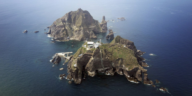 A set of remote islands called Dokdo in Korean and Takeshima in Japanese is seen in this picture taken from a helicopter carrying South Korean President Lee Myung-bak (not pictured), east of Seoul August 10, 2012. Lee visited the islands on Friday, angering neighbour Japan which also lays claims to territory. South Korea controls the islands with a coast guard presence and plans to beef up maritime research. REUTERS/The Blue House/Handout (POLITICS) FOR EDITORIAL USE ONLY. NOT FOR SALE FOR