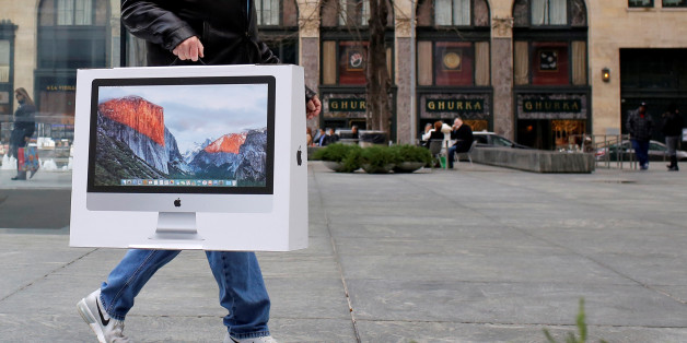 A man carries a newly purchased iMac from the Apple Fifth Avenue store during Black Friday sales in Manhattan, New York, U.S., November 25, 2016. REUTERS/Andrew Kelly
