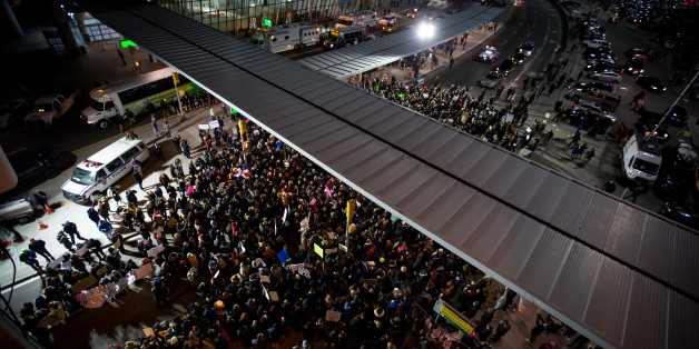 Demonstrators gather outside John F. Kennedy International Airport (JFK) to protest U.S. President Donald Trump's executive order blocking visitors from seven predominantly Muslim nations in New York, U.S., on Saturday, Jan. 28, 2017. A U.S judge temporarily blocked the Trump administration from enforcing an executive order that would have led to the deportation of refugees and visa-holders from seven mostly Muslim countries. Photographer: Michael Nagle/Bloomberg via Getty Images