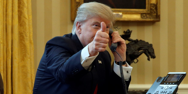 U.S. President Donald Trump gives a thumbs-up to reporters as he waits to speak by phone with the Saudi Arabia's King Salman in the Oval Office at the White House in Washington, U.S. January 29, 2017. REUTERS/Jonathan Ernst