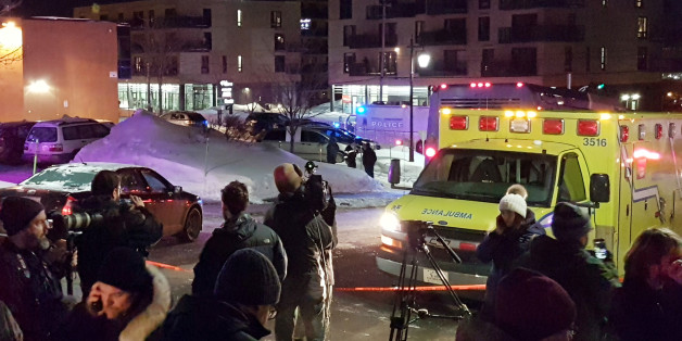 An ambulance is parked at the scene of a fatal shooting at the Quebec Islamic Cultural Centre in Quebec City, Canada January 29, 2017. REUTERS/Mathieu Belanger