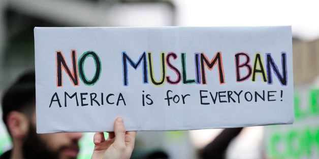 PORTLAND, UNITED STATES - JANUARY 29: A protester holds a banner during a demonstration against President Trump's immigration ban at Portland International Airport in Portland, United States on January 29, 2017. The President signed an executive order on Friday suspending all refugee admissions for 120 days as well as blocking entry for citizens from seven Muslim-majority countries for 90 days. (Photo by Alex Milan Tracy/Anadolu Agency/Getty Images)
