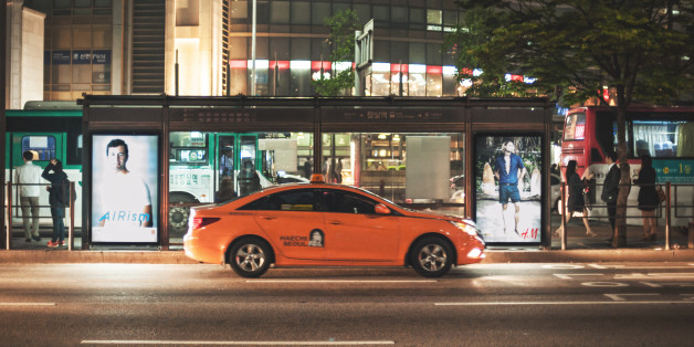 Seoul, Republic of Korea - May 12, 2014: Orange taxis cruising the streets at night Jamsil range