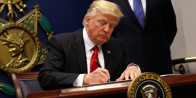U.S. President Donald Trump signs an executive order to impose tighter vetting of travelers entering the United States, at the Pentagon in Washington, U.S., January 27, 2017. The executive order signed by Trump imposes a four-month travel ban on refugees entering the United States and a 90-day hold on travelers from Syria, Iran and five other Muslim-majority countries. Picture taken January 27, 2017. REUTERS/Carlos Barria