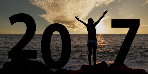 Person silhouette standing in 2017 on the hill at sunset