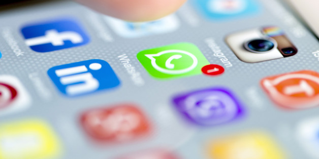 Istanbul, Turkey - September 18, 2015: Apple Iphone 6 screen with social media applications of Whatsapp, Facebook, Instagram, Viber, Linkedin, Tango, Perisfind and Snapchat while a male finger is about to touch on Whatsapp app.