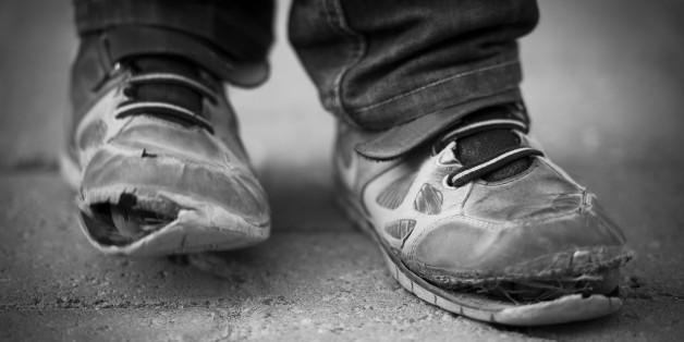 Village boy in Turkey wearing pair of old shoes.