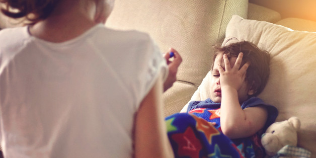 mother checking her sons temperature