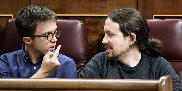 Podemos' leader Pablo Iglesias (R) looks at Podemos' representative Inigo Errejon at the Spanish Congress (Las Cortes) on October 26, 2016, in Madrid during the first day of the parliamentary investiture debate to vote through a prime minister.
Spain's acting Prime Minister Mariano Rajoy warned of a tough road ahead today as he prepares to take power again at the head of a minority government with very little support.
/ AFP / JAVIER SORIANO (Photo credit should read JAVIER SORIANO/AFP/Getty Images)