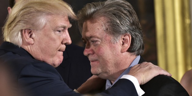 US President Donald Trump (L) congratulates Senior Counselor to the President Stephen Bannon during the swearing-in of senior staff in the East Room of the White House on January 22, 2017 in Washington, DC. / AFP / MANDEL NGAN (Photo credit should read MANDEL NGAN/AFP/Getty Images)
