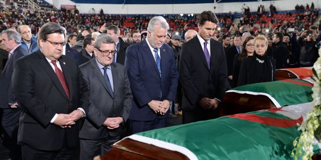 Canadian Prime Minister Justin Trudeau (right to left) Quebec Premier Philippe Couillard, Quebec City Mayor Regis Labeaume and Montreal Mayor Denis Coderre pay their respects by the caskets of the six victims of the Quebec City mosque shooting at the Maurice Richard Arena in Montreal,on February 2, 2017.Canadian Prime Minister Justin Trudeau on Thursday attended the funeral of two Algerians and a Tunisian man killed with three others in a mosque shooting, as he seeks to pull together a nation sh