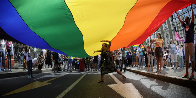 A woman dances under a huge rainbow flag during the Gay Pride parade in Belgrade on September 18, 2016.
The Belgrade Gay Pride parade, the third in a row since the event was marred by violence in 2010, was held without incidents amid tight security as thousands of riot police officers were deployed in the city center. / AFP / Oliver BUNIC (Photo credit should read OLIVER BUNIC/AFP/Getty Images)