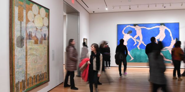 Visitors look at artwork by Iranian painter and sculptor Charles Hossein Zenderoudi -- K+L+32+H+4 Mon pere et moi, 1962' (L)-- at The Museum of Modern Art on February 3, 2017 in New York City.The famed New York art museum has joined the throng of protests against US President Donald Trump's travel ban by replacing Western art with pieces by Iranian, Iraqi and Sudanese-born artists. The Museum of Modern Art said the seven works by Sudanese painter Ibrahim el-Salahi, the late Iraqi-born architect