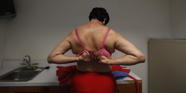 Ana Rico, 57, buckles her bra after receiving an ultrasound scan for breast cancer detection at a centre run by the "Reto" Group for Full Recovery of Breast Cancer in Mexico City October 18, 2012. Breast cancer has been the leading cause of death in Mexican women since 2006, according to the group. The World Day Against Breast Cancer is commemorated on October 19. REUTERS/Edgard Garrido (MEXICO - Tags: HEALTH ANNIVERSARY)