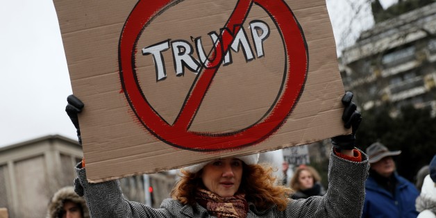TOPSHOT - An anti-Trump protester holds a sign during a demonstration in Paris, on February 4, 2017.
US President Donald Trump lashed out on February 4, 2017 at a court ruling suspending his controversial ban on travelers from seven Muslim countries, dismissing it as 'ridiculous' and vowing to get it overturned. The order blocking the ban, issued late on February 3, 2017 by Seattle US District Judge James Robart, is valid across the United States, pending a full review of a complaint filed by Washington state's attorney general. / AFP / THOMAS SAMSON (Photo credit should read THOMAS SAMSON/AFP/Getty Images)