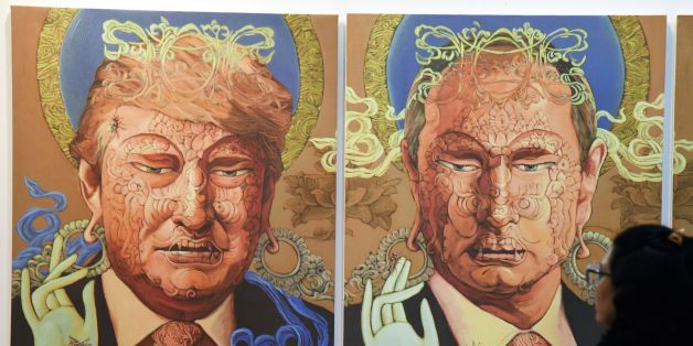A visitor looks at a painting representing US President Donald Trump (L) and Russian President Vladimir Putin made by Nepalese artist Sunil Sidgel at the India Art Fair in New Delhi on January 2, 2017. / AFP / Dominique FAGET / RESTRICTED TO EDITORIAL USE - MANDATORY MENTION OF THE ARTIST UPON PUBLICATION - TO ILLUSTRATE THE EVENT AS SPECIFIED IN THE CAPTION (Photo credit should read DOMINIQUE FAGET/AFP/Getty Images)