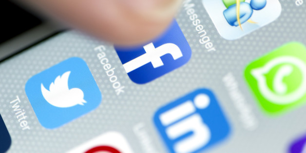 Istanbul, Turkey - September 18, 2015: Apple Iphone 6 screen with social media applications of Whatsapp, Facebook, Twitter, Linkedin and Periscope while a male finger is about to touch on Facebook app.
