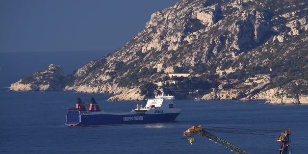 The cargo ship 'Stena Carrier' of the Corsica Linea shipping company, which employs foreign sailors and must start sea crossings between Marseille and Bastia in place of the SNCM shipping company, is anchored offshore on January 5, 2016, near the harbour of Marseille, after it was preventing from docking by SNCM and La Meridionale sailors on strike. / AFP / ANNE-CHRISTINE POUJOULAT (Photo credit should read ANNE-CHRISTINE POUJOULAT/AFP/Getty Images)