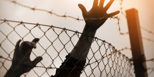 Refugee men and fence. Refugee concept