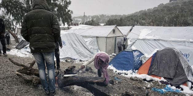 Migrants try to light a fire during snowfall at the Moria hotspot on the Greek island of Lesbos, on January 9, 2017.
With more than 60,000 mainly Syrian refugees on its territory, Greece has moved many migrants to prefabricated houses and heated tents, but on the island of Lesbos in Moria hotspot there are 'more than 2,500 people living in tents, without hot water or heating, including women, children and handicapped people,' said Apostolos Veizis from the charity Doctors Without Borders. / AFP / STR (Photo credit should read STR/AFP/Getty Images)
