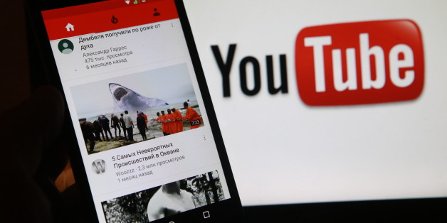ST PETERSBURG, RUSSIA - DECEMBER 2, 2016: A smartphone with the mobile version of the Youtube video sharing website on the screen, in front of a computer screen showing the Youtube logo, Sergei Konkov/TASS (Photo by Sergei Konkov\TASS via Getty Images)