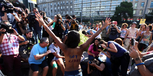 A woman poses topless with the words "I am free" written on her back during a protest in response to a recent incident on an Argentine resort beach between police and topless sunbathers, in downtown Buenos Aires, Argentina, February 7, 2017. REUTERS/Marcos Brindicci