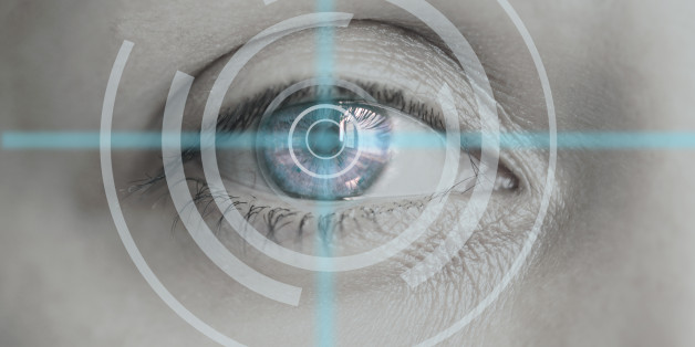 Male eye with radiating light and blue iris.
