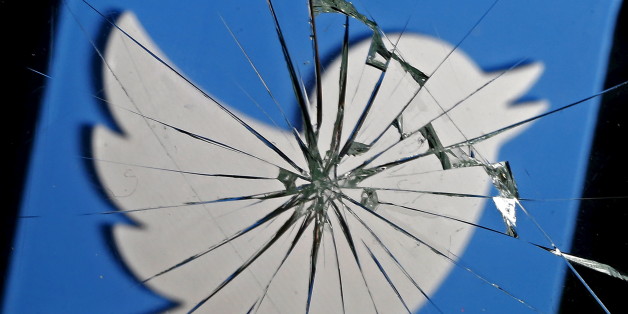 A 3D-printed Twitter logo is seen through broken glass, in this picture illustration taken February 8, 2016. Twitter shed 5.4 percent to hit a new record low of $14.87 after reports over the weekend that the company was planning to change how it display tweets. REUTERS/Dado Ruvic/Illustration