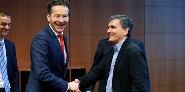 Dutch Finance Minister and Eurogroup President Jeroen Dijsselbloem greets Greek Finance Minister Euclid Tsakalotos (R) during a euro zone finance ministers meeting in Brussels, Belgium December 5, 2016. REUTERS/Francois Lenoir