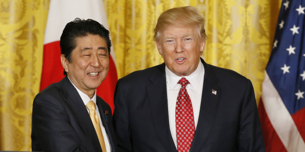 Japanese Prime Minister Shinzo Abe (L) and U.S. President Donald Trump shake hands following their joint press conference at the White House in Washington, U.S., February 10, 2017. REUTERS/Jim Bourg TPX IMAGES OF THE DAY