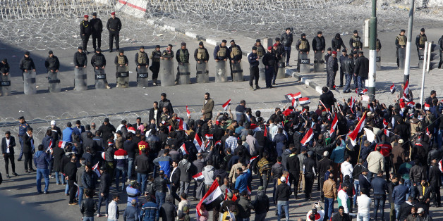 Iraqi security forces stand guard as supporters of the Sadrist movement gather during a demonstration in Baghdad's Tahrir Square on February 11, 2017, to demand the formation of an independent electoral commission. / AFP / SABAH ARAR (Photo credit should read SABAH ARAR/AFP/Getty Images)