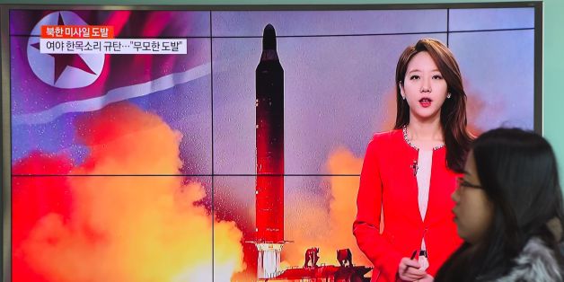 A woman walks past a television screen showing file footage of North Korea's missile launch at a railway station in Seoul on February 12, 2017.
North Korea fired a ballistic missile on February 12 in an apparent provocation to test the response from new US President Donald Trump, the South Korean defence ministry said. / AFP / JUNG Yeon-Je (Photo credit should read JUNG YEON-JE/AFP/Getty Images)