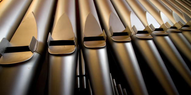 A wide angle photograph of a church organ in natural light