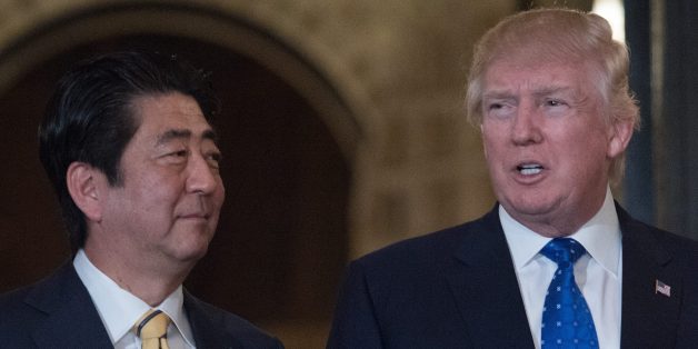 US President Donald Trump and Japanese Prime Minister Shinzo Abe pose for photos at Trump's Mar-a-Lago resort in Palm Beach, Florida, on February 11, 2017 prior to dinner. / AFP / NICHOLAS KAMM (Photo credit should read NICHOLAS KAMM/AFP/Getty Images)