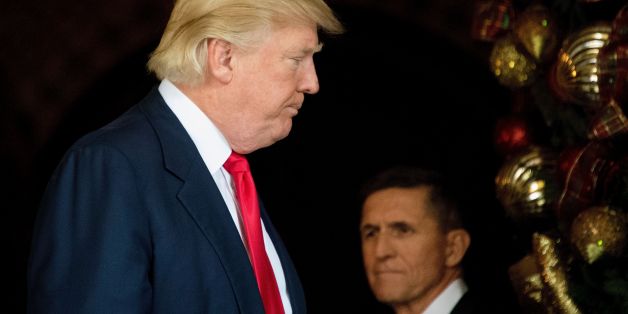 US President-elect Donald Trump (L) stands with Trump National Security Adviser Lt. General Michael Flynn (R) at Mar-a-Lago in Palm Beach, Florida, where he is holding meetings on December 21, 2016. / AFP / JIM WATSON (Photo credit should read JIM WATSON/AFP/Getty Images)