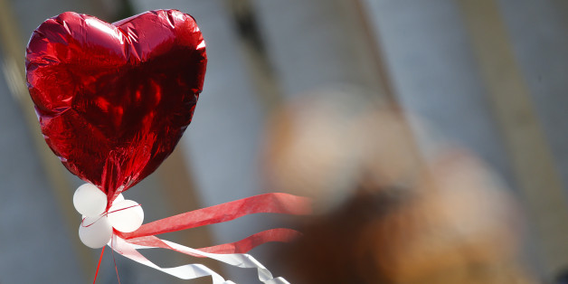 A heart-shaped balloon flies as Pope Francis leads a special audience with engaged couples, to celebrate Saint Valentine's day, in Saint Peter's Square at the Vatican February 14, 2014. REUTERS/Tony Gentile (VATICAN - Tags: RELIGION)