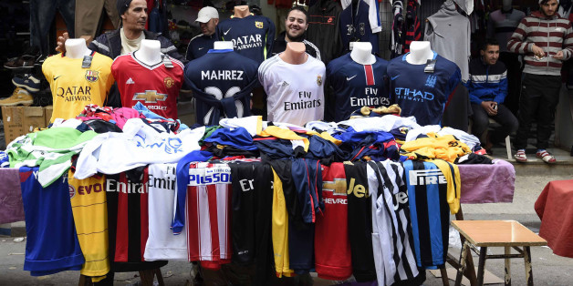 An Algerian vendor displays shirts of football players at a market on February 18, 2016 in the old part of the capital Algiers, known as the Casbah. English club Leicester City's midfielder, Riyad Mahrez shirts are flying off the shelves of sports shops in Algiers as the Algerian winger continues to impress for Premier League leaders Leicester City. / AFP / Farouk Batiche (Photo credit should read FAROUK BATICHE/AFP/Getty Images)