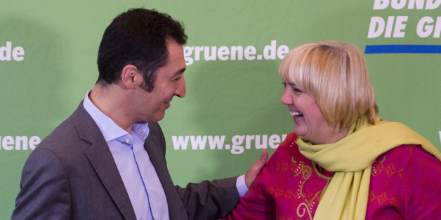 German green Party Die Gruenen co-leaders Cem Oezdemir (L) and Claudia Roth (R) greet each other at the start of a meeting of her party's executive board at their headquarters in Berlin, on September 30, 2013, as exploratory talks with Chancellor's victorious conservatives on forming a coalition government are expected a week after German elections. German Chancellor Angela Merkels CDU announced today it will start talks with the centre-left Social Democratic Party (SPD) on October 4, 2013 on f