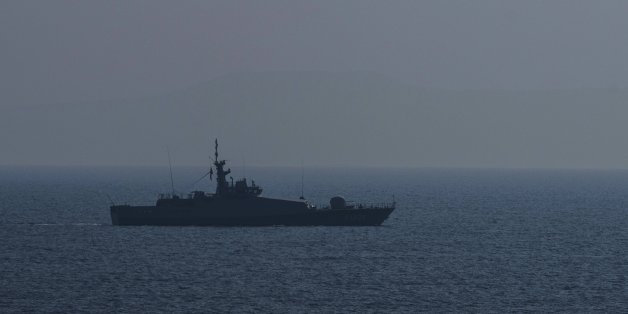 A Turkish warship and a coast guard helicopter patrol the egean sea between Turkish coast and Lesbos island on March 21, 2016 at Kucukkuyu district in Canakkale western Turkey.
Greece will not be able to start sending refugees back to Turkey from March 20, 2016, the government said, as the country struggles to implement a key deal aimed at easing Europe's migrant crisis. Under the agreement clinched between Brussels and Anakara last week, migrants who reach the Greek islands will be deported back to Turkey. For every Syrian returned, the EU will resettle one from a Turkish refugee camp. / AFP / OZAN KOSE (Photo credit should read OZAN KOSE/AFP/Getty Images)