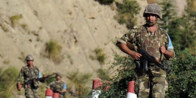 Algerian troops conduct a search operation on October 10, 2014, near the village of Ait Ouabane, 80 kilometres south of Tizi Ouza, for the body of 55-year old French tourist and moutain-guide Herve Gourdel, who was kidnapped on September 21 while hiking in Algeria's Djurdjura National Park, and beheaded three days later by a group linked to Islamic State jihadists in Iraq and Syria. Algeria is continuing to devote significant resources in Kabylia to find the body of Gourdel Herve and locate his