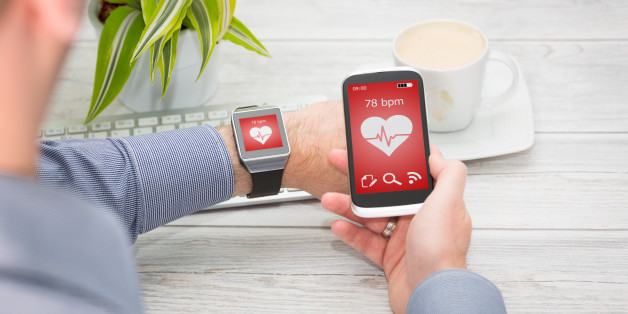 Businessman uses smart watch and phone. Smartwatch concept.