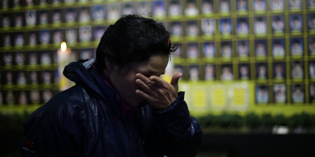 SEOUL, SOUTH KOREA - APRIL 16: A South Korean woman pays tribute at a group memorial altar for victims of the sunken ferry Sewol during the second anniversary of the Sewol disaster on April 16, 2016 in Seoul, South Korea. On April 16, 2014, the Sewol ferry carrying 476 passengers capsized off of Jindo Island in South Korea. Only 172 of the ferry's 476 passengers and crew were rescued, and out of the 304 dead or missing, 250 were school children. (Photo by Chung Sung-Jun/Getty Images)