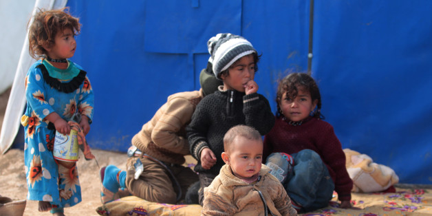 Displaced Iraqi children sit at the Al-Agha camp where Iraqi families from the nearby villages of Tal Afar, southwest of Mosul, are taking shelter as Iraqi forces continue their military operation to recapture Mosul from Islamic State (IS) jihadists on February 16, 2017. / AFP / AHMAD AL-RUBAYE (Photo credit should read AHMAD AL-RUBAYE/AFP/Getty Images)