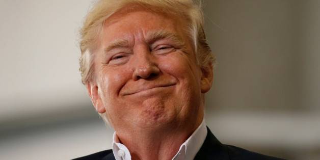 U.S. President Donald Trump smiles a as he holds a "Make America Great Again" rally at Orlando Melbourne International Airport in Melbourne, Florida, U.S. February 18, 2017. REUTERS/Kevin Lamarque TPX IMAGES OF THE DAY