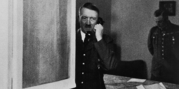 German Nazi leader Adolf Hitler (1889 - 1945) takes a phone call at Wolfsschlucht I - his headquarters at Bruly-de-Pesche, Belgium, May-June 1940. (Photo by Hulton Archive/Getty Images)