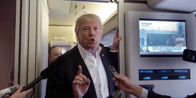 US President Donald Trump speaks to the press aboard Air Force One before addressing a rally in Melbourne, Florida, on February 18, 2017. / AFP / NICHOLAS KAMM (Photo credit should read NICHOLAS KAMM/AFP/Getty Images)