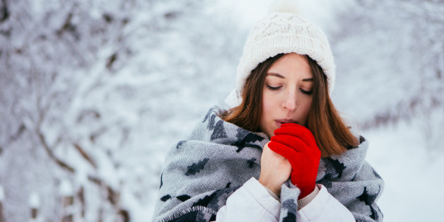 Winter woman portrait. Winter clothing not so worm so she holds scarf to get wormer.