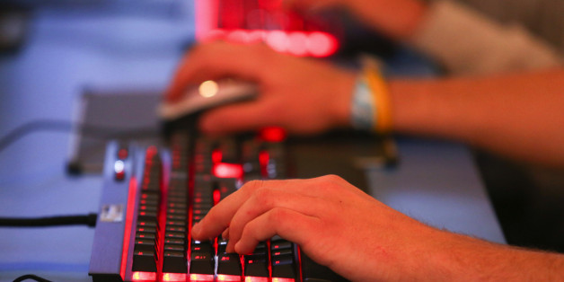Visitos use keyboards to play computer games during the EGX gaming conference at Earls Court in London, U.K., on Thursday, Sept. 25, 2014. Sony Corp. will begin selling its PlayStation TV set-top box in the U.S. and Europe next month with almost 700 games available, including select Angry Birds, Borderlands, Lego and FIFA soccer titles. Photographer: Chris Ratcliffe/Bloomberg via Getty Images