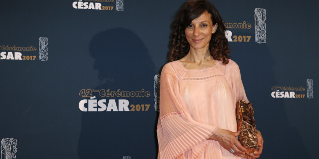 Director Houda Benyamina poses with her trophy during a photocall after receiving the Best First Film Award for her film "Divines" at the 42nd Cesar Awards ceremony in Paris, France, February 24, 2017. REUTERS/Gonzalo Fuentes